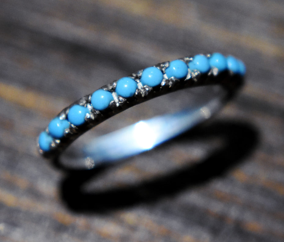 Ring with blue turquoise  stones on a textured surface